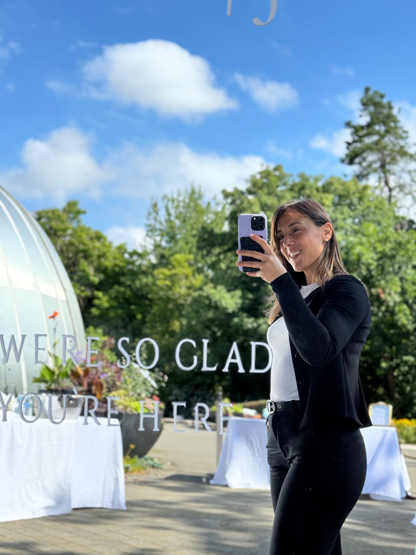 Founder of Between the Vines Italy capturing a moment at an outdoor wedding celebration